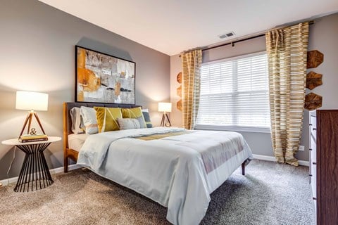 Legacy at Fox Valley Queen Sized Bedroom with Carpet Flooring and Large Window with Coverings